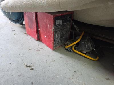 a red box under a white car that is under the car