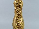 an antique gold plated candle holder with a bird on it
