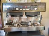 une image représentant une machine à café sur laquelle sont posés des casseroles et des poêles