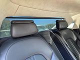 the interior of a car with a sunroof and leather seats
