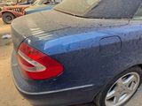a blue car that is parked on the side of the street