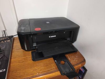 a printer sitting on top of a wooden desk