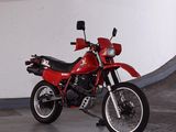 a red motorcycle that is parked in a parking garage