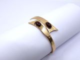a close up of a gold ring on a napkin