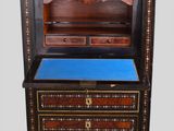 an image of a small cabinet with drawers and a blue top