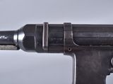 a close up of a gun on a white surface