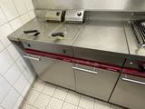 stainless steel counter top in a commercial kitchen with a griddle burner