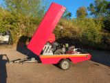 a red and yellow boat with a engine in the back of it