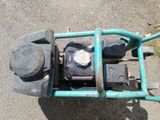 a lawn mower that is sitting on the ground