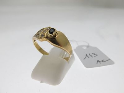 Gros plan sur une bague en or ornée d'une pierre noire
