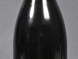 a black bottle with a red top on a table