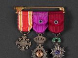 several medals are displayed on a black surface with a black background