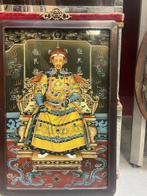 an image of a statue of a man sitting on a throne