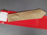 a piece of fabric on a red piece of paper