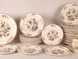 a lot of plates and bowls that are sitting on a table