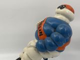 figurine of a football player holding a ball on a base