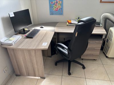a desk with a computer and a laptop on it