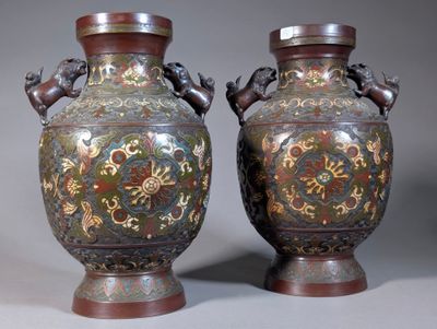 two vases that have been decorated with designs on them