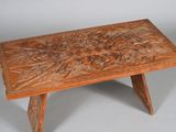an image of a wooden table with a carved design on top of it