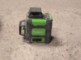 a green and black camera sitting on the ground