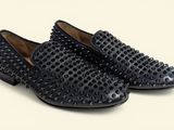 black studded loafer shoes on a white background