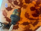 a glass vase with a light on it and a cord attached to it