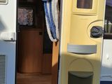 a blue and white striped curtain hanging from the side of a camper