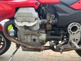 a close up of a motorcycle engine on a street