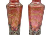two vases sitting side by side on a white background