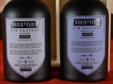 two bottles of gin sauvage on a red table cloth
