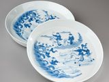 two plates with blue and white designs on them