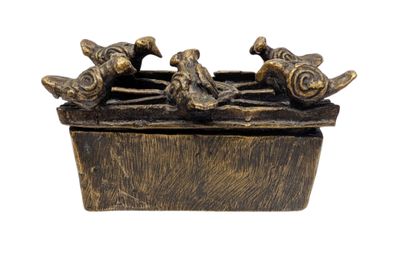 a bronze statue of birds sitting on top of a wooden box