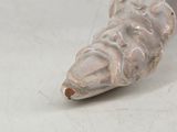 a white vase that has a piece of art on it