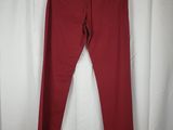 a pair of red jeans hanging on a white curtain