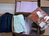 a cardboard box filled with assorted items on a table