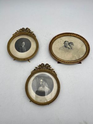 three framed pictures of a man and a woman are shown on a white surface