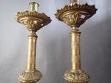 two candles that are sitting next to each other on a table