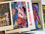 four paintings of different colors and sizes on a table