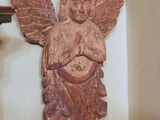 a statue of an angel on a wall next to a door