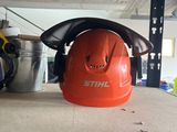 an orange hard hat sitting on top of a table