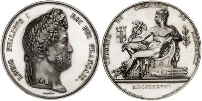 an image of a silver coin with a bust of a woman and a bust of a man