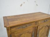 a wooden cabinet that has a door on top of it