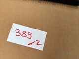a close up of a pen sitting on top of a cardboard box