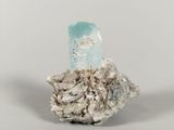 a small piece of rock with a blue crystal on it