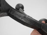 a hand that is holding a pair of scissors in it ' s left hand
