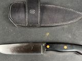 two knives on the table next to each other