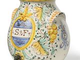 a vase with a lid that has a picture of a bird on it