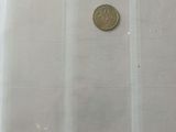 four different coins in a plastic case on a table