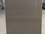 an image of a stainless steel refrigerator in a warehouse