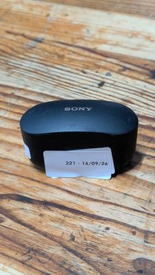 a close up of a remote control sitting on top of a wooden table